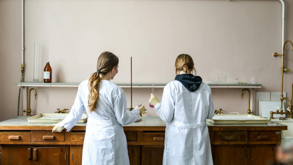 Women In White Laboratory Gown Standing