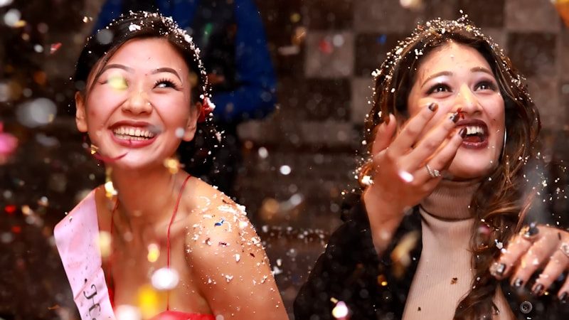 time-lapse photography of two women splashing glitters
